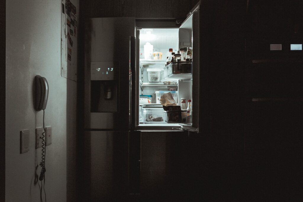 an open fridge door with food inside
