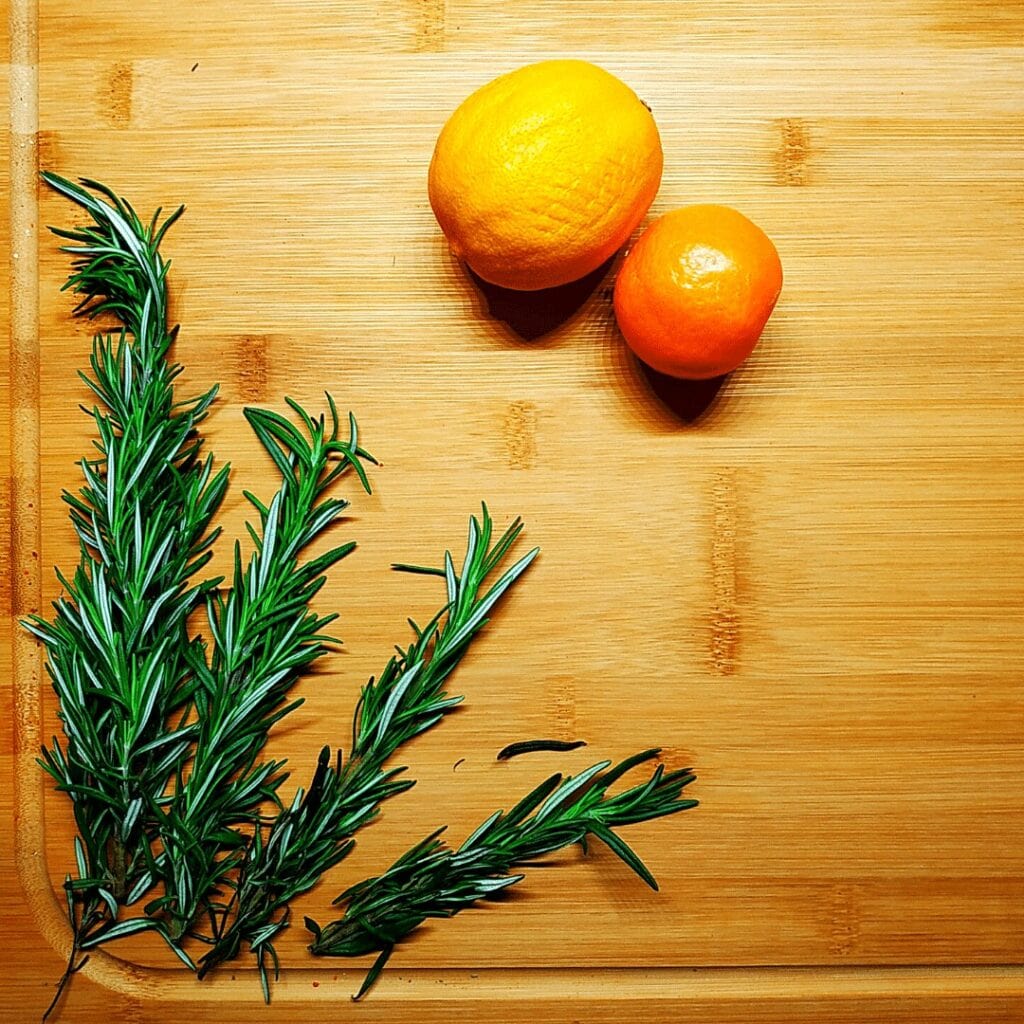 #12 of most popular spices is whole sprigs of Rosemary pictured here on a cutting board