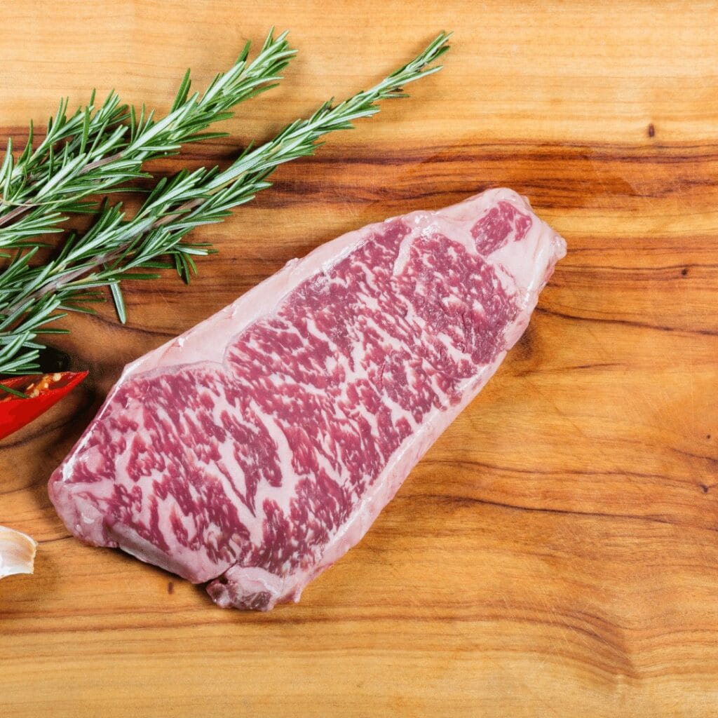 A slice of wagyu steak with marbling. Tips on how to cook wagyu on grill