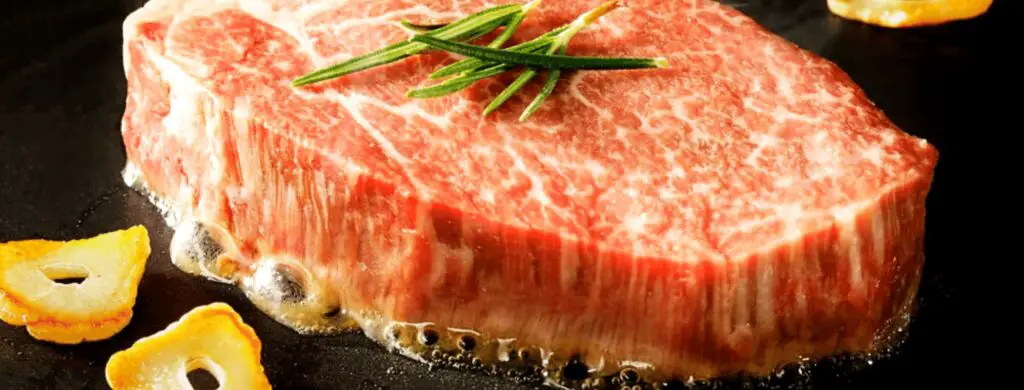 How Long Should I Cook Wagyu Steak intro image featuring a sizzling piece of steak